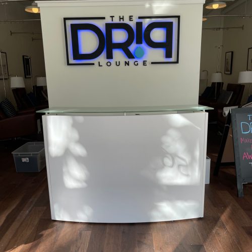 Wall with the logo of The Drip Lounge